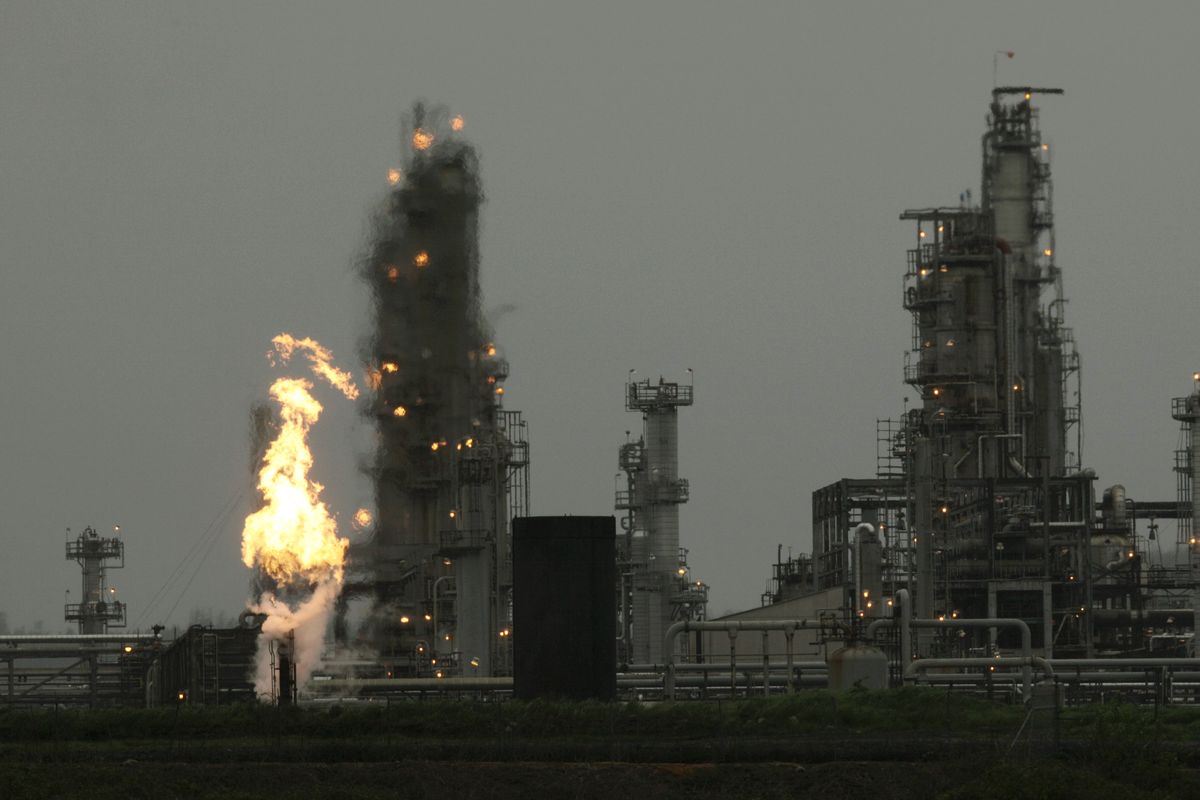 A Tesoro Corp. refinery, including a gas flare flame that is part of normal plant operations, is shown Friday, April 2, 2010, in Anacortes, Wash. An overnight fire and explosion at the refinery killed three people and critically injured four others who were working at the plant. (Ted Warren / Associated Press)
