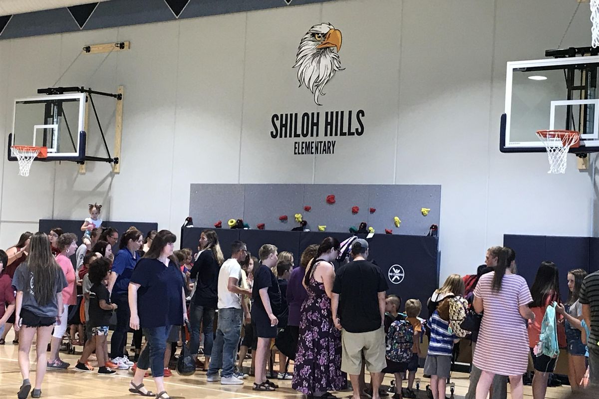 Shiloh Hills Elementary School families pick out new backpacks in the school gym during the school’s dedication Tuesday. (Nina Culver / The Spokesman-Review)