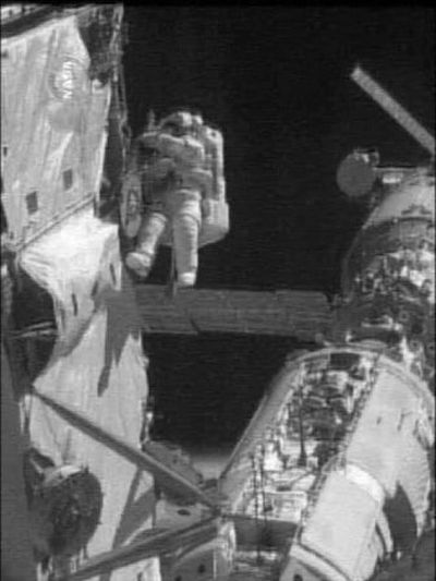 
In this  NASA video image,  flight engineer Sunita Williams maneuvers outside the International Space Station during a space walk Sunday.
 (Associated Press / The Spokesman-Review)