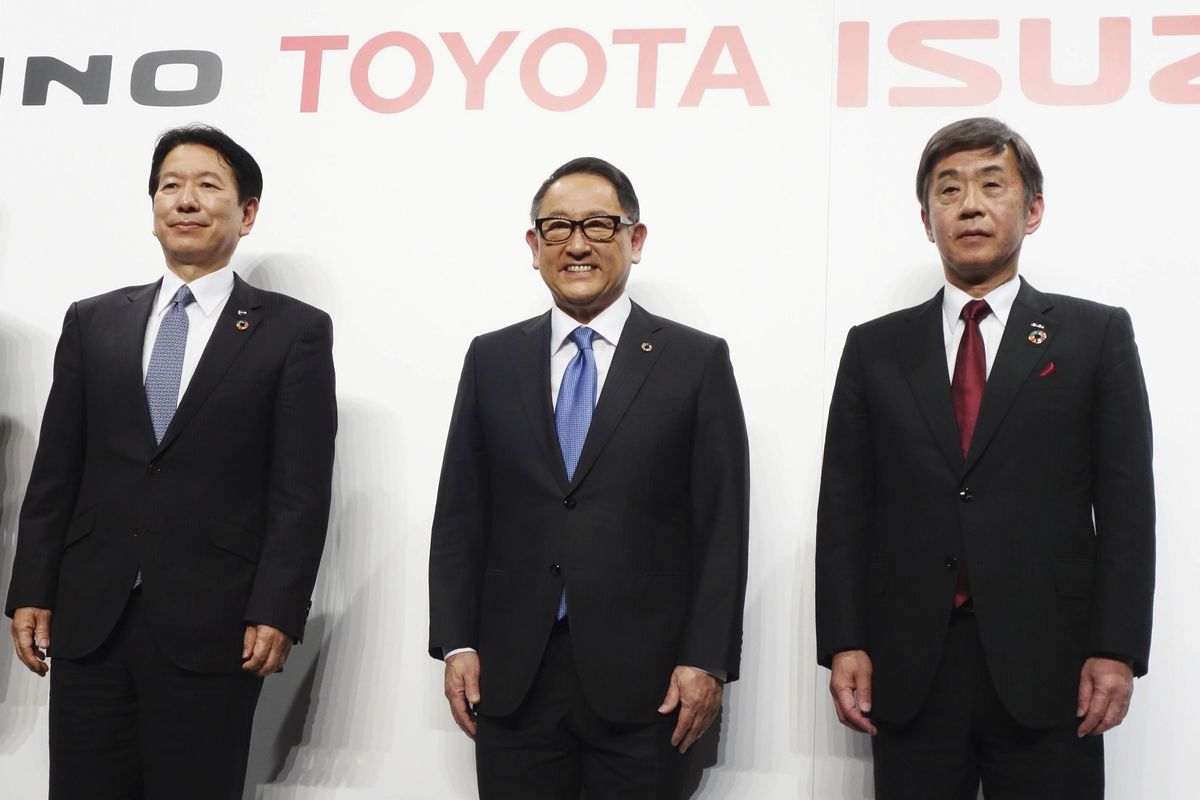 From left, Hino Motors President Yoshio Shimo, Toyota Motor Corp. President Akio Toyoda and Isuzu Motors President Masanori Katayama pose for a photo in Tokyo Wednesday, March 24, 2021. Japanese automakers Toyota, Isuzu and Hino said Wednesday they are setting up a partnership in commercial vehicles to work together in electric, hydrogen, connected and autonomous driving technologies.  (SUB)