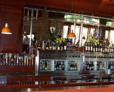 
The massive cherry-oak bar at Bardenay features microbrews and chilled wines on tap, as well as a variety of liquors for unique mixed concoctions.
 (Patrick Jacobs / The Spokesman-Review)