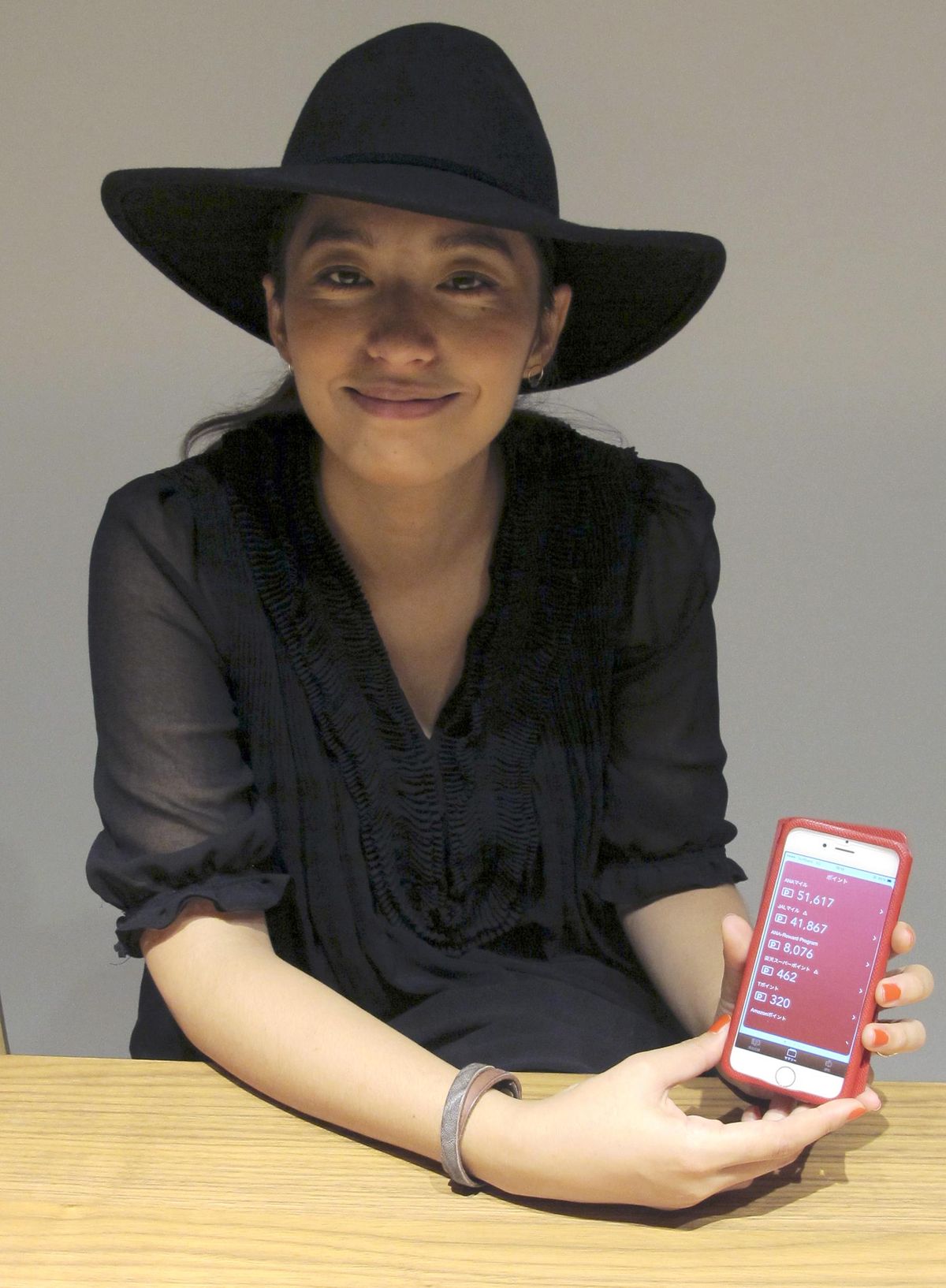Japanese singer Miho Fukuhara, brand ambassador of Moneytree, shows her discount point on Moneytree App on her mobile phone during an interview, in Tokyo on Oct. 19. Moneytree, with a staff of 18, has developed iPhone and iPad applications that allows people to track personal finances, attracting 850,000 downloads over three years. (Yuri Kageyama / Associated Press)
