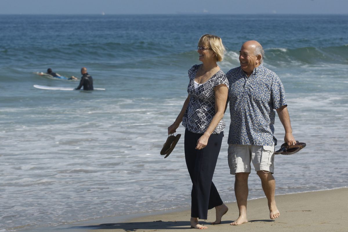 Susie Martin, 54, and Patrick Webster, 63, walk barefoot in the sand near their home in Redondo Beach, Calif., on May 13.
