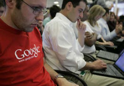 
Google employees work on their laptops at Google headquarters in Mountain View, Calif. Google Inc. reported a 46 percent jump in earnings for the fiscal third quarter on Thursday.Associated Press
 (File Associated Press / The Spokesman-Review)