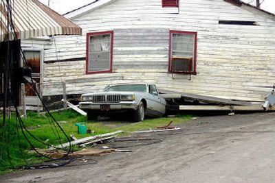 A home rests on top of a car in New Orleans after Hurricane Katrina. Although this picture was taken in March, similar damage can still be seen across the city.
(Craig Parker / The Spokesman-Review)