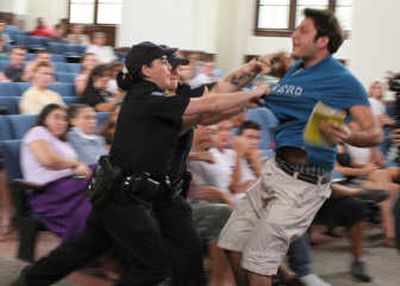 
University of Florida student Andrew Meyer struggles with university police as officers try to remove him from a question and answer session with Sen. John Kerry, D-Mass., Monday. Associated Press
 (Associated Press / The Spokesman-Review)