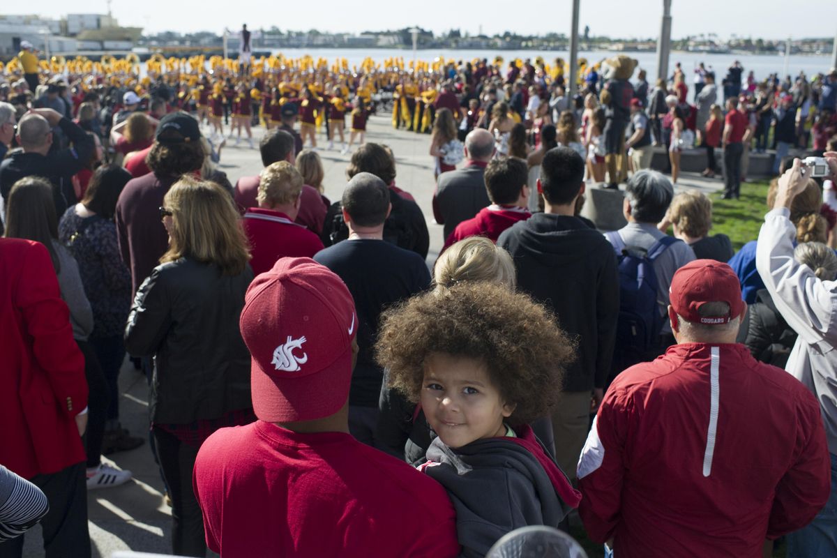 Chris Garofola, father of WSU safety Deion Singleton holds daughter Sophia, 4, as they watch the WSU Marching Band play during a Battle Of The Bands with the Minnesota Golden Gophers band before the 2016 Holiday Bowl on Monday, Dec. 26, 2016, at The Hilton Bayfront in San Diego, Calif. (Tyler Tjomsland / The Spokesman-Review)