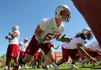 
WSU defensive end Matt Mullennix, center, and defensive tackle Fevaea'i Ahmu, right, get in some work during the first day of football practice in Pullman on Sunday.
 (Christopher Onstott/ / The Spokesman-Review)