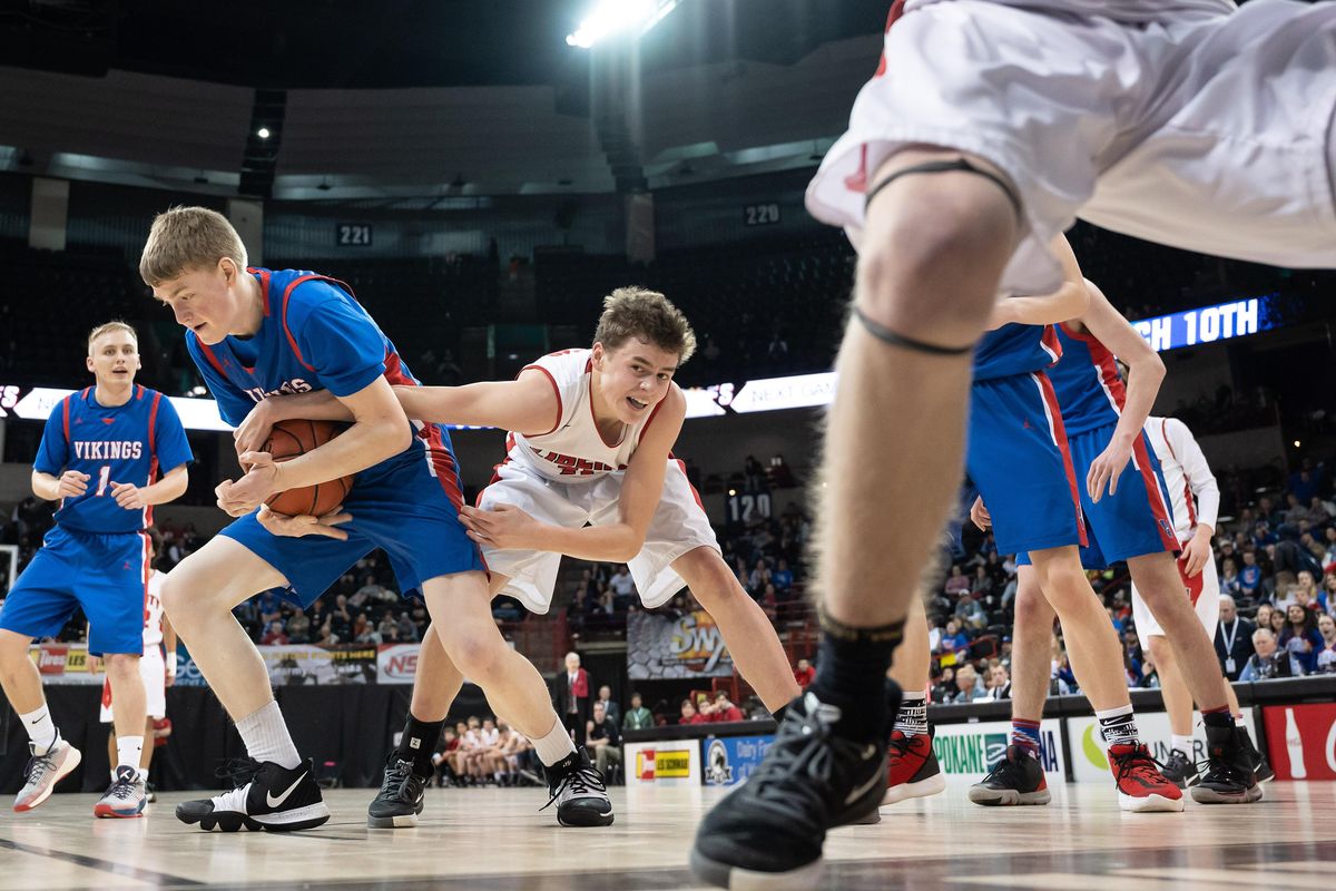 Willapa Valley forward Allen Deniston (32) and Liberty guard Colton Marsh (on right) compete for control of a rebound during a WIAA State 2b Hardwood Classic basketball game, Thurs., March 5, 2020, in the Spokane Arena. (Colin Mulvany / The Spokesman-Review)