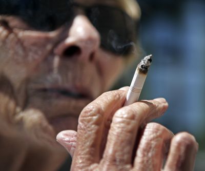 Helen Heinlo smokes outside of a coffee shop in Belmont, Calif., in 2007. A new federal study suggests menthol cigarettes are likely more risky to smokers’ health. (Associated Press)