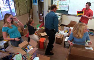 
Several students in Ferris High School teacher Ted Barnwell's classroom pack about 20 care packages to go to Iraq. 
 (Jed Conklin / The Spokesman-Review)