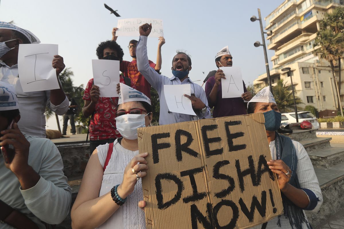 Members of Aam Aadmi Party shout slogans demanding the release of Indian climate activist Disha Ravi, during a protest in Mumbai, India, Monday, Feb. 15, 2021. The 22 years old activist was arrested Saturday for circulating a document on social media that allegedly incited protesting farmers to turn violent last month.  (Rafiq Maqbool)