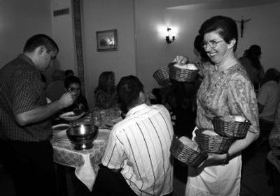 
Sister Milena smiles as she distributes bread baskets to guests staying at Fraterna Domus guest house in Rome.
 (Associated Press / The Spokesman-Review)