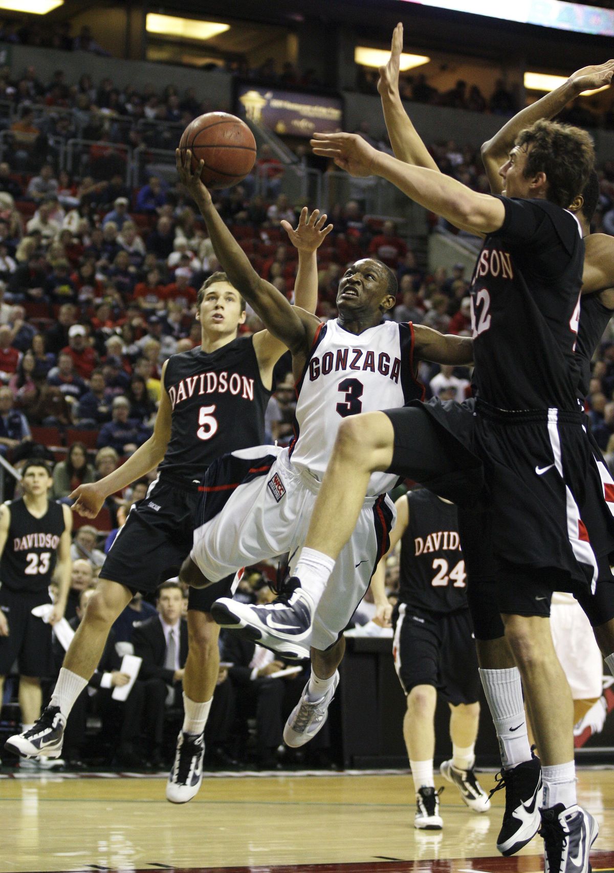 Gonzaga guard Demetri Goodson (3) drives to the basket as Davidson guard JP Kuhlman, left, and Davidson forward Ben Allison, right, defend in the first half of an NCAA college basketball game, Saturday, Dec. 12, 2009, in Seattle. (Ted Warren / Associated Press)