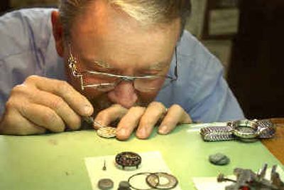 
Watchmaker Larry Verhaag repairs the hands of a watch at Halpins in Spokane Valley Friday. 
 (Holly Pickett / The Spokesman-Review)