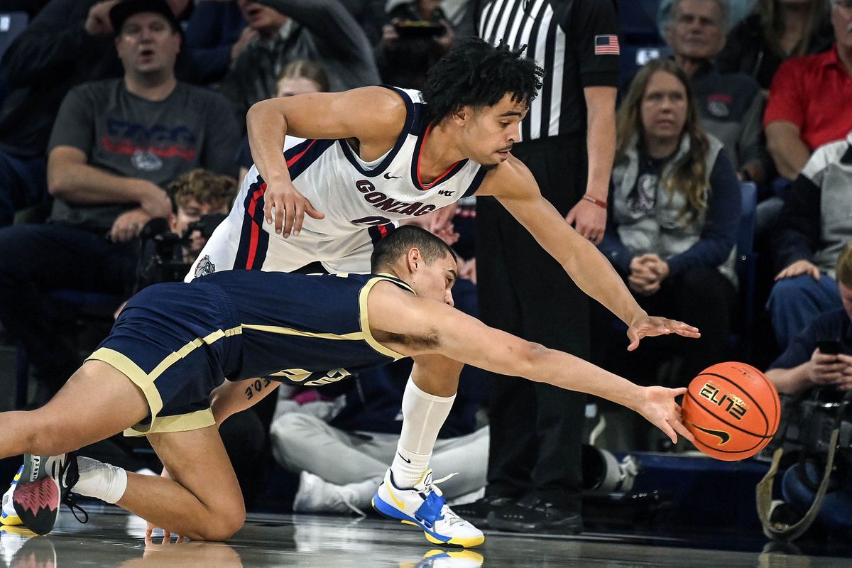 Gonzaga guard Ryan Nembhard (0) and Eastern Oregon guard Malachi Afework (10) chase a loose ball during the first half of a NCAA college basketball game, Tuesday, Nov. 14, 2023, in the McCarthey Athletic Center.  (COLIN MULVANY/THE SPOKESMAN-REVIEW)
