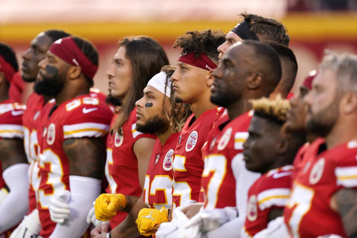 In this Sept. 10, 2020 photo, Kansas City Chiefs players stand for a presentation on social justice before an NFL football game against the Houston Texans, in Kansas City, Mo. The NFL