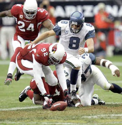 
Seahawks' quarterback Matt Hasselbeck and Arizona's Bertrand Berry battle for the loose ball after a fourth-quarter fumble. Associated Press
 (Associated Press / The Spokesman-Review)
