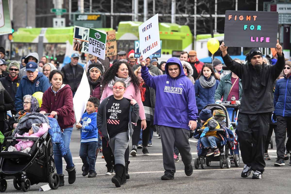 Hundreds of people walk along Riverside Avenue during the March for Life Northwest, Saturday, Jan. 12, 2019, in downtown Spokane, Wash. (Dan Pelle / The Spokesman-Review)