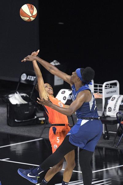 Minnesota Lynx center Sylvia Fowles, right, deflects a shot by Connecticut Sun guard Jasmine Thomas (5) during the second half of a WNBA basketball game Sunday, July 26, 2020, in Bradenton, Fla.  (Associated Press)