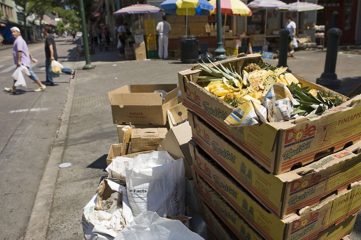 Garbage sits on the sidewalk in Honolulu’s Chinatown. Once known for its sugar cane and pineapples, Hawaii’s next big export to the U.S. mainland could be less sweet – 100,000 tons of trash. Oahu is looking to ship the bulk of its municipal waste to the West Coast.  (Associated Press / The Spokesman-Review)