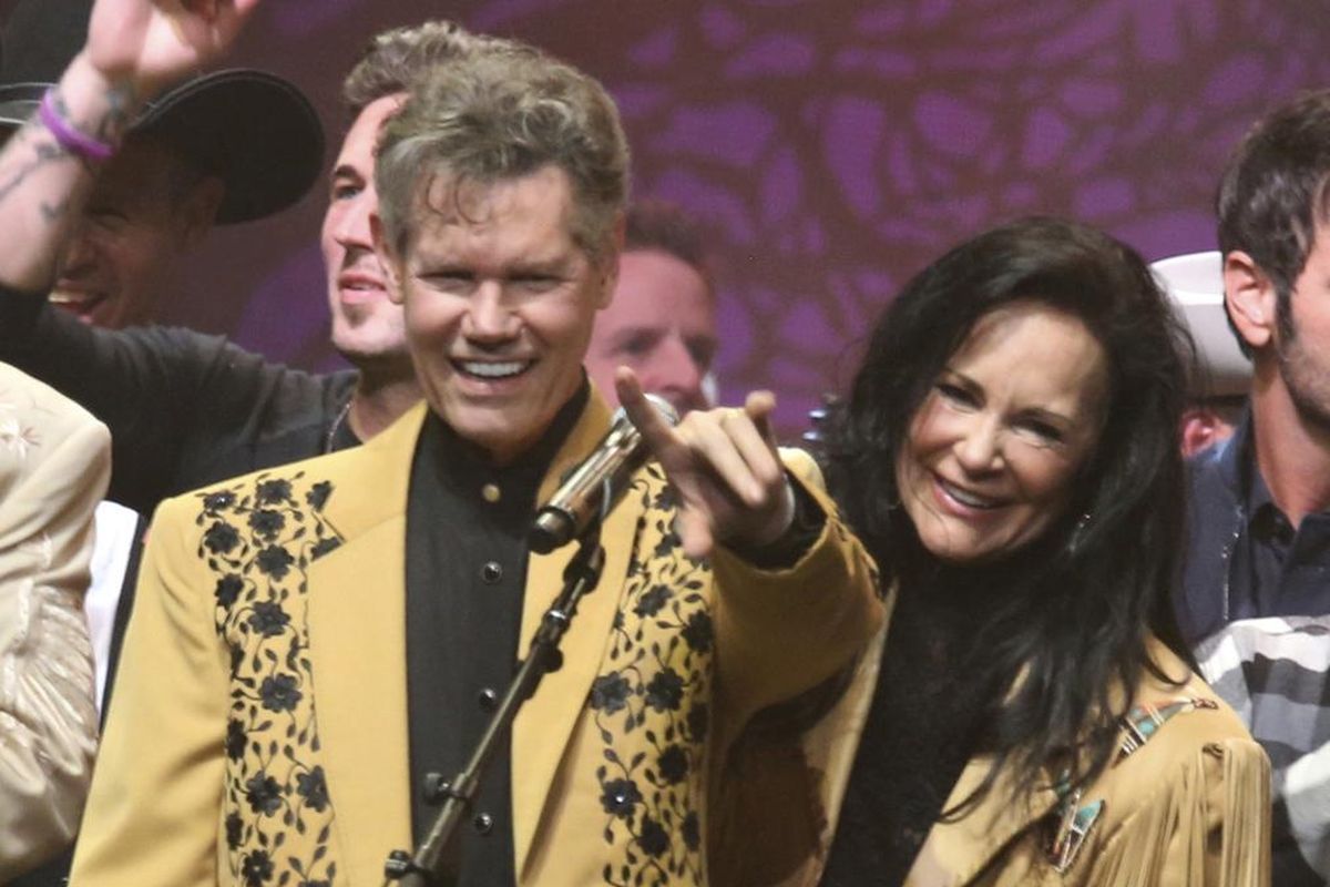 This Feb. 8, 2017, file photo shows country singer Randy Travis, left, and his wife Mary Travis at the “1 Night. 1 Place. 1 Time.: A Heroes and Friends Tribute to Randy Travis” in Nashville, Tenn. Travis, who survived a near fatal stroke in 2013 that left him with a limited ability to speak, released his first memoir, “Forever and Ever, Amen: A Memoir of Music, Faith and Braving the Storms of Life,” chronicling his rise to fame. (Laura Roberts / Laura Roberts/Invision/AP)