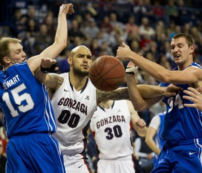Chasing a rebound, Gonzaga center Robert Sacre (00) parts the way between Air Force guard Taylor Stewart (15) and center Taylor Broekhuis (34) during the first half of their NCAA college basketball game Thursday, Dec. 22, 2011, in the McCarthey Athletic Center in Spokane, Wash. COLIN MULVANY colinm@spokesman (Colin Mulvany / The Spokesman-Review)