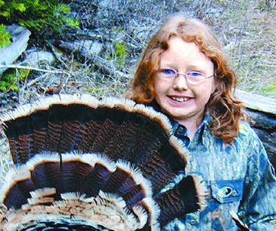Elizabeth Odell, age 9, with a wild turkey she bagged with her 20-gauge shotgun on opening day for youth hunting.
(Photo by Dick Odell / The Spokesman-Review)