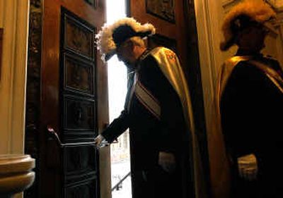 
James Pugh, Faithful Navigator of The Knights of Columbus, closes the doors of Our Lady of Lourdes Cathedral prior to Thursday's memorial service for Pope John Paul ll. 
 (Brian Plonka / The Spokesman-Review)
