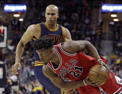 Chicago’s Jimmy Butler (right) drives past Cleveland’s Richard Jefferson (24) in the first half of Saturday’s game. The Bulls won 117-99. (Tony Dejak / Associated Press)