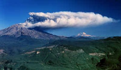 
Mount St. Helens erupts with a plume of steam and ash Monday morning in this view looking north toward the mountain with Mount Rainier in the background. 
 (Associated Press / The Spokesman-Review)