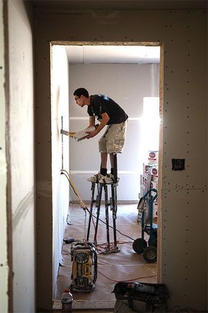 Robert Ferra with Custom Drywall helps with the taping process during home construction Friday in the Lake Forest West development in Coeur d’Alene off of Ramsey Road and Canfield Avenue. (Kristen McPeek / Coeur d'Alene Press)