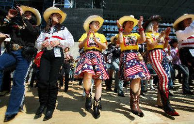 
Japanese country music enthusiasts perform a line dance during the 18th Country Gold country music festival in Kumamoto, southwestern Japan. 
 (Associated Press photos / The Spokesman-Review)