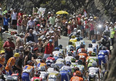 The pack, led by Rinaldo Nocentini of Italy, negotiates a tight curve toward Aspin Pass on Sunday. (Associated Press / The Spokesman-Review)