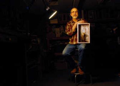 
Dan McCann with an example of his artwork, Dec. 28, in Spokane. McCann works in mixed media, sculpting and box construction. 
 (Brian Plonka / The Spokesman-Review)
