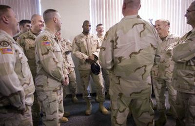 
Members of Bravo Battery, 2nd Battalion 146th Field Artillery share a laugh before a ceremony in their honor Saturday in Spokane. At left, Kathy Weidinger wipes tears during the Army Hymn at the ceremony. Among the Washington National Guardsmen honored was her son, Staff Sgt. Larry Weidinger.
 (The Spokesman-Review)