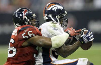 
Texans linebacker Morlon Greenwood tackles Denver's Selvin Young.Associated Press
 (Associated Press / The Spokesman-Review)