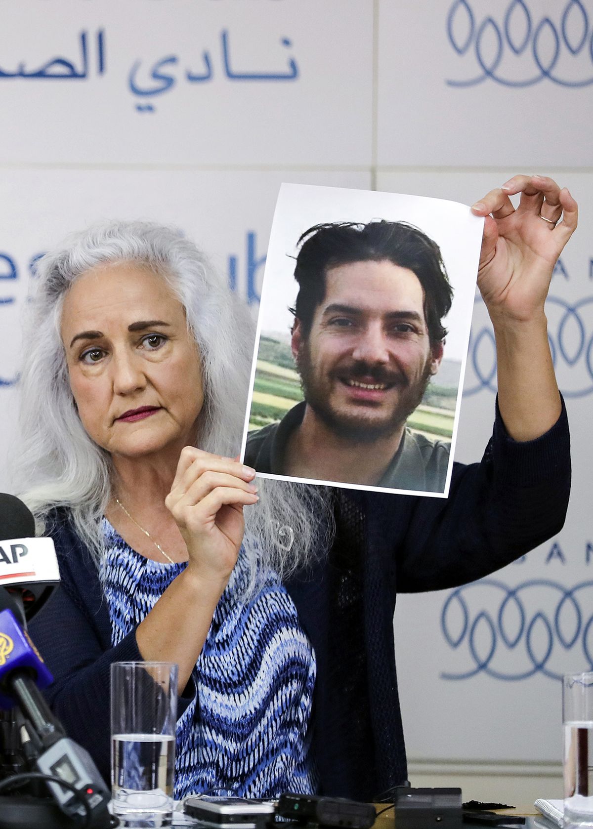 Debra Tice, mother of U.S. journalist Austin Tice, who was kidnapped in Syria five years prior, holds a dated portrait of him during a press conference in the Lebanese capital Beirut on July 20, 2017. (Joseph Eid/AFP/Getty Images North America/TNS)