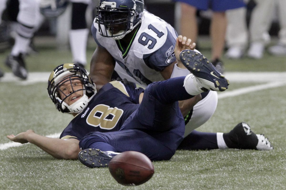 Rams quarterback Sam Bradford fumbles while being sacked by Seattle’s Chris Clemons in the third quarter. The Seahawks recovered. (Associated Press)