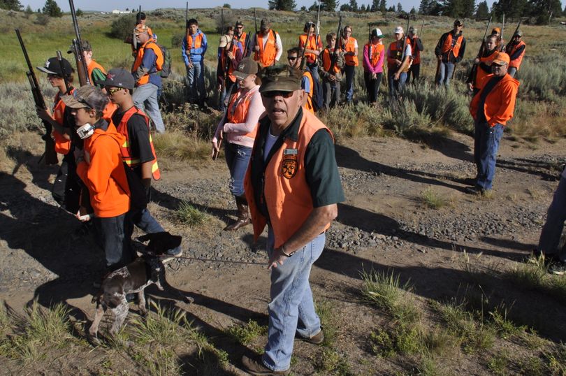 Hunter education instructor Jack Dolan assembles his summer class of 40 students and 17 volunteer instructors at the Espanola dog training grounds near Medical Lake for a field session geared to learning how to hunt and safely shoot upland birds over pointing dogs. (Rich Landers)