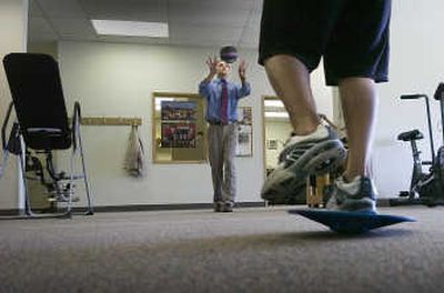 
Kelly Risse, left, throws a ball to Mathew Proost during a physical therapy session this summer. Physical Therapy Associates donates its services free to injured Lewis and Clark High School athletes. 
 (CHRISTOPHER ANDERSON / The Spokesman-Review)