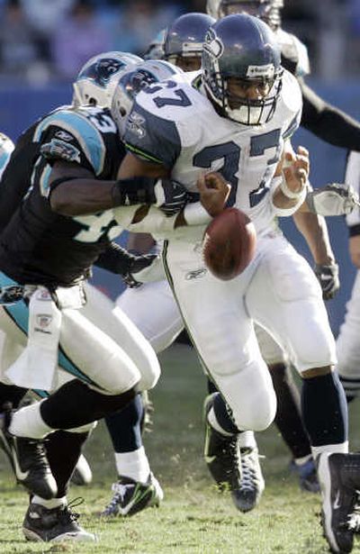 
Shaun Alexander fumbles after being hit by Carolina's Chris Harris, but Seattle was able to recover the ball. Associated Press
 (Associated Press / The Spokesman-Review)