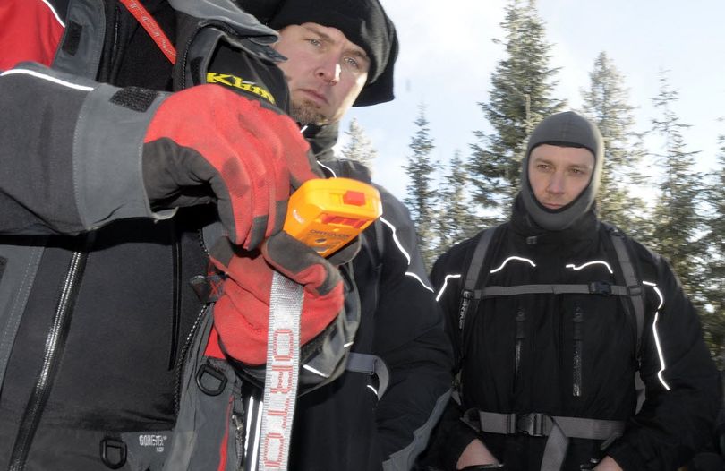 Larry Dowd ( back center ) and James Mittelstadt ( rear right ) of Rathdrum, Idaho learn about avalanche beacons in an Avalanche Awareness Class during a demonstration at the Fourth of July snowmobile area today.  (Christopher Anderson / The Spokesman-Review)