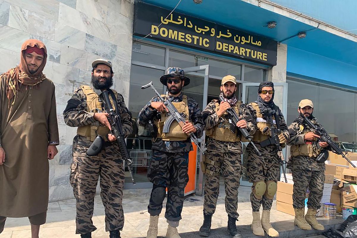 Taliban fighters stand guard inside the Hamid Karzai International Airport after the U.S. withdrawal in Kabul, Afghanistan, Tuesday, Aug. 31, 2021. The Taliban were in full control of Kabul