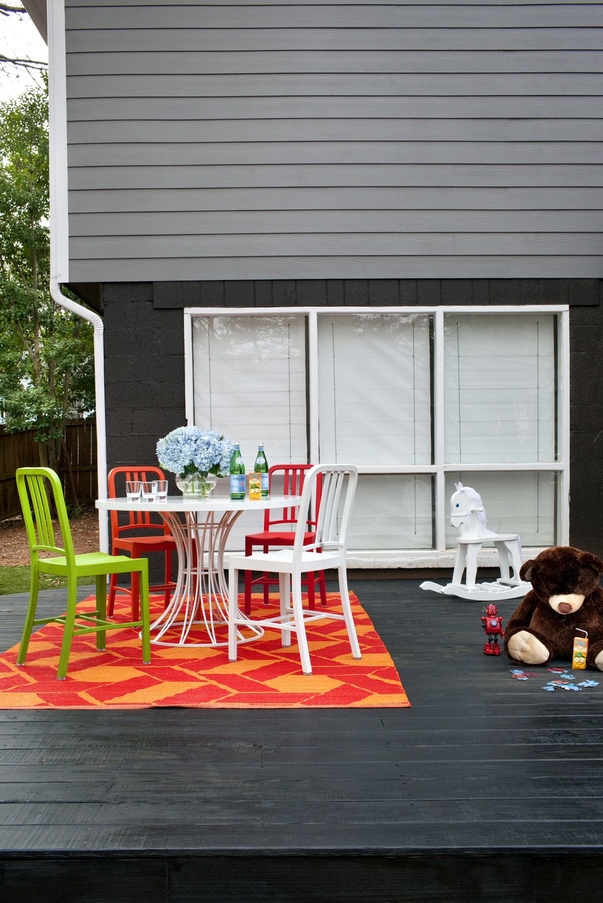 A porch designed by Brian Patrick Flynn features colorful indoor/outdoor