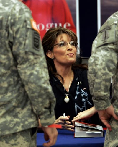 Former Alaska Gov. Sarah Palin signs a copy her her autobiography, 