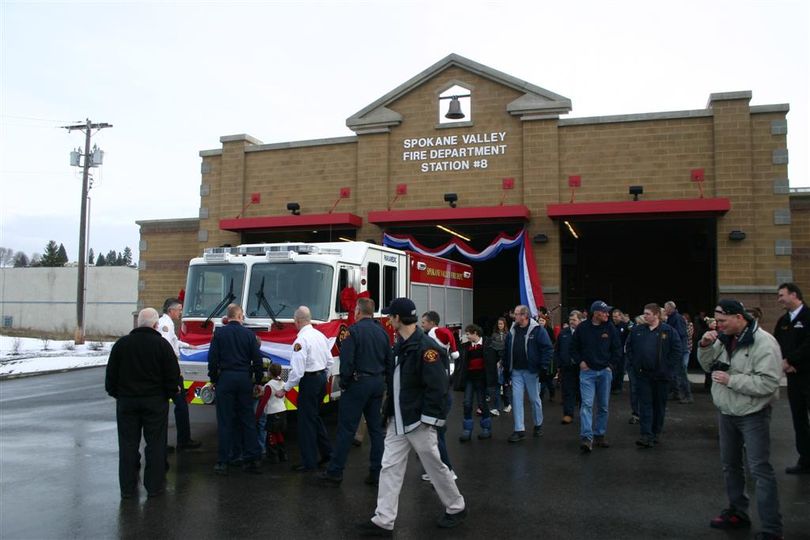 Spokane Valley Fire Department employees are joined by members of the community to help push the new Rescue 8 truck into its station during a housing ceremony on Dec. 23. The photo is courtesy of the Spokane Valley Fire Department. (Photo courtesy Spokane Valley Fire Department)