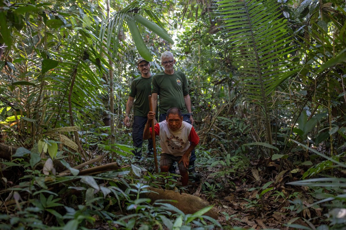 Jair Candor, right, a tracker of isolated tribes, with his deputy tracker, Rodrigo Ayres, behind Pakyi, one of the three known remaining members of the Piripkura tribe, Brazil’s smallest known tribe, in Piripkura Indigenous Territory, July 26, 2023. The trackers comb the Amazon rainforest looking for elusive Indigenous people to satisfy a Brazilian law that requires proof that isolated groups exist before their land can be placed off limits to outsiders. (Victor Moriyama/The New York Times)  (VICTOR MORIYAMA)