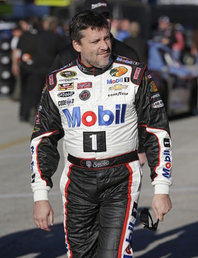 Tony Stewart walks to his garage before practice for the Sprint Unlimited exhibition. (Associated Press)