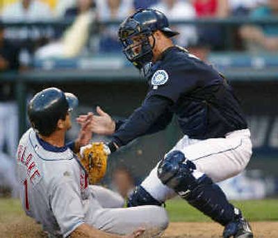 
Dan Wilson tags out Indians' Casey Blake as Blake fails to score on a fly out to Raul Ibanez in left field.
 (Associated Press / The Spokesman-Review)